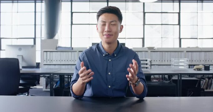Close up of people talking to the camera, businessman in office explaining, sitting at desk