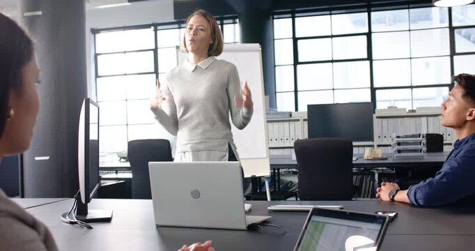 Lifestyle videos indoor of people doing activities at office, leading business meeting, woman presen