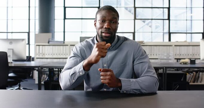 Close up of people talking to the camera, businessman in office sitting at desk, gesturing