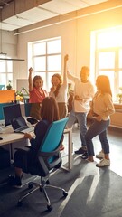 Fototapeta premium Group of enthusiastic young creative professionals celebrating office success together.