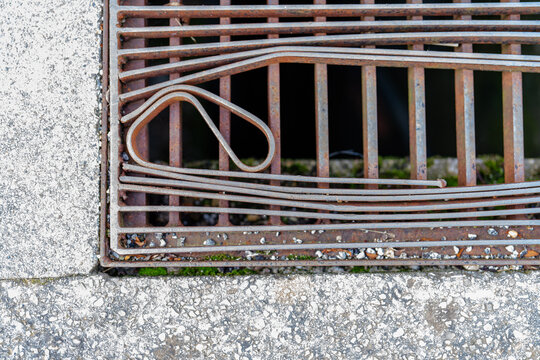 Rusty metal grate with decorative geometric detail