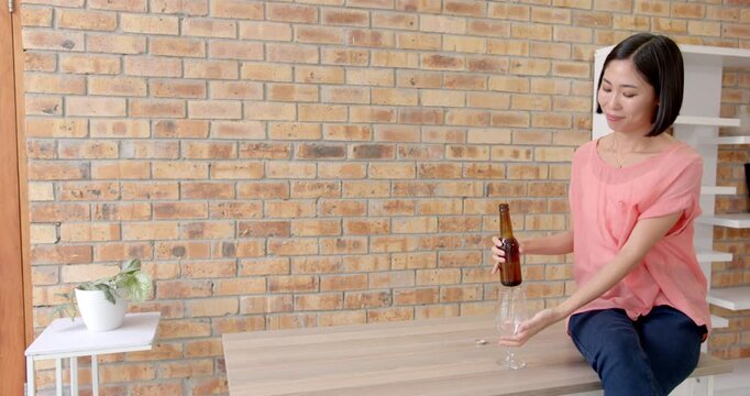 Lifestyle videos indoor of people doing activities at office, pouring beer into glass, woman sitting