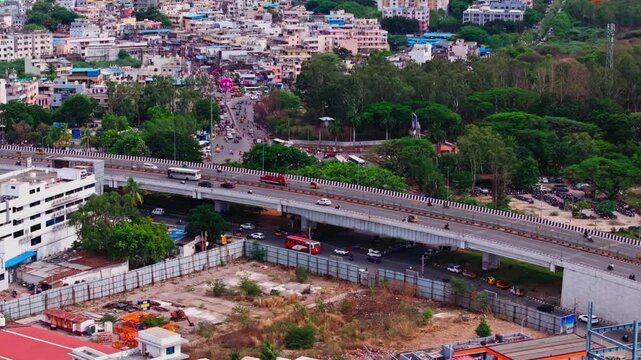 Traffic flow on bhel flyover with underpass road, Residential buildings and bhel township at lingampally, hyderabad, telangana, india. day time, static shot, drone shot, 4k.