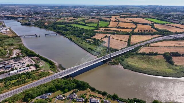 Amazing Aerials Ireland high orbit of landmark bridge spanning the River Suir and linking Kilkenny and Waterford majestic Thomas Francis Meagher Bridge