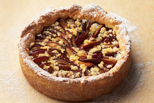 Plum cake on baking paper, studio shot