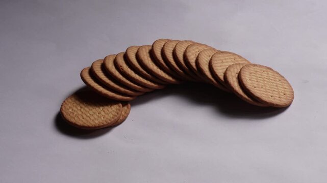 Hands Arranging Row of Round Biscuits