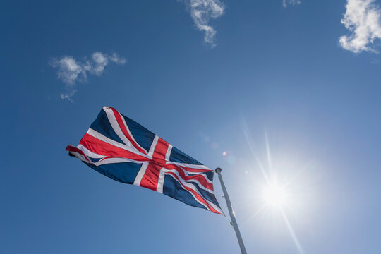 Union Jack in blue sky with backlight