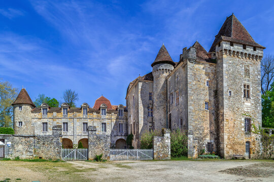 Chateau de la Marthonie in France, frontal view. Historical medieval stone castle under bright daylight