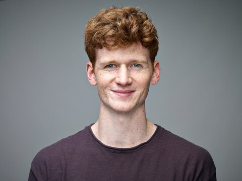 Portrait of smiling redheaded young man