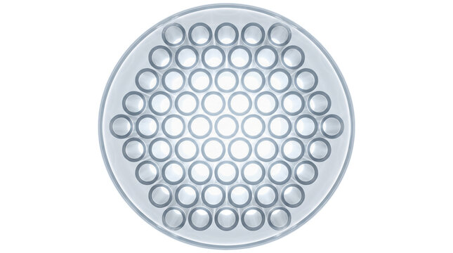 Overhead perspective showing many hollow clear glass capillary tubes packed tightly together forming perfect geometric honeycomb structure against solid white background