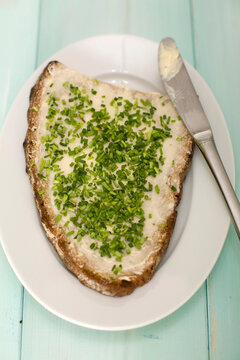 Bread and butter on plate with chives