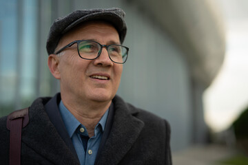Fototapeta premium Mature man in flat cap looking upwards