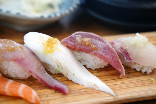 Top view of assorted premium sushi platter on a wooden board
