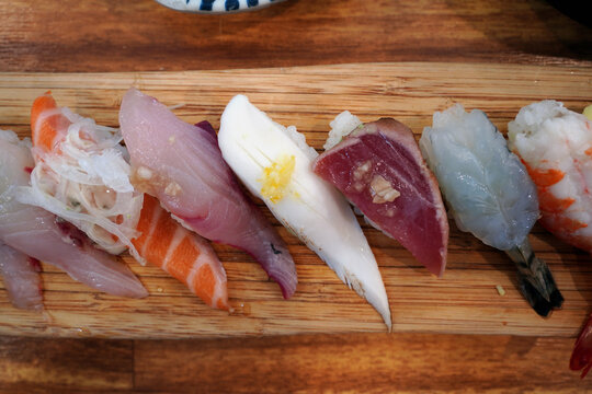 Top view of assorted premium sushi platter on a wooden board