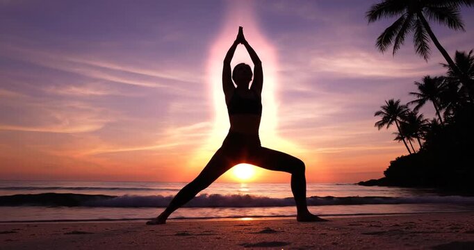Woman Silhouette Practicing Yoga on Beach at Sunset Surya Namaskar. Silhouette woman yoga center angle on the beach at sunset. 4K Video 60 fps