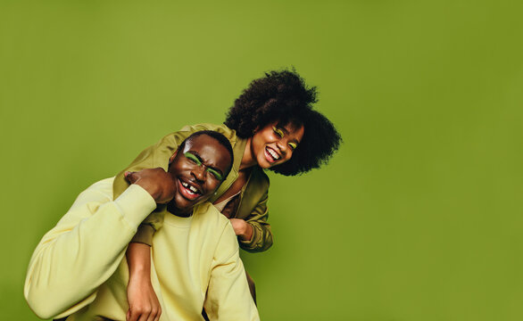 Friends dancing together in studio with playful energy and bold youth style