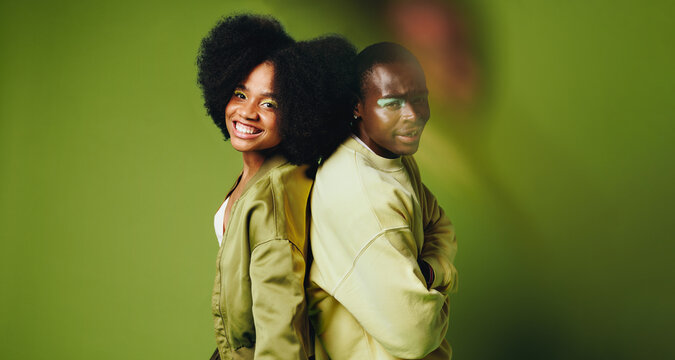 Colorful friends pose back to back in a studio portrait with dance energy