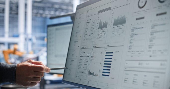 RD Engineer Performs Digital Design Inspection of Robotic Machinery on Interactive Display, Using Stylus to Highlight Components, Review Specifications, and Coordinate Mechanical and Control Work.