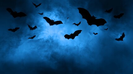 Obraz premium Blue halloween background with flying bats, spooky night sky, dark blue texture, eerie atmosphere, mysterious horror theme, creepy seasonal backdrop, halloween celebration, haunted night concept, fest