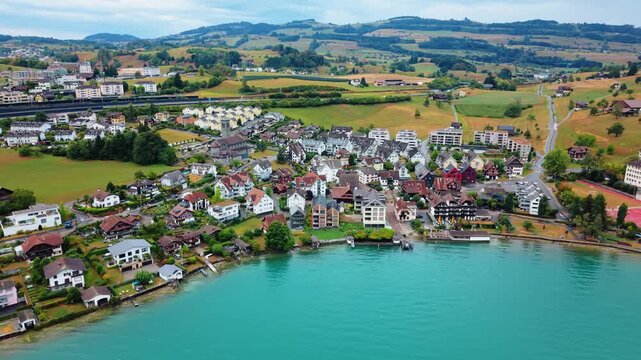 Aerial view of Immensee village with its traditional houses and lush green hills along the shores of Lake Zug in Kussnacht, Schwyz, Switzerland.
