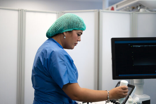 Medical professional working with ultrasound machine for diagnostic imaging
