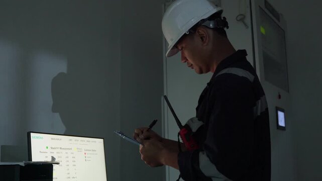 Footage engineer using computer check analysis continuous emissions monitoring system for air pollution reduction. Sustainable environment technology data information Concept energy saving, control 