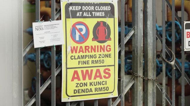 Close-up of a private parking warning sign in Malaysia with a towing notice, emphasizing restricted parking rules and urban property management, UHD