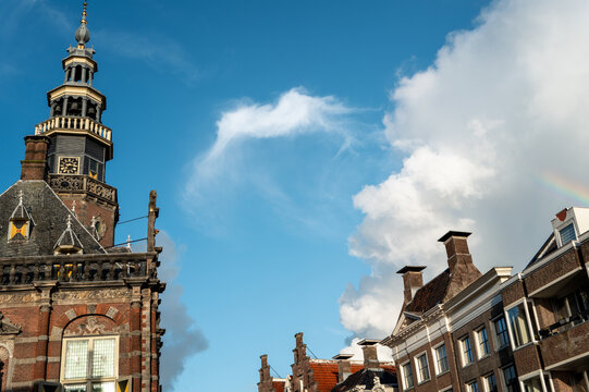 Clear sky with clouds above historic buildings in a European city during daylight