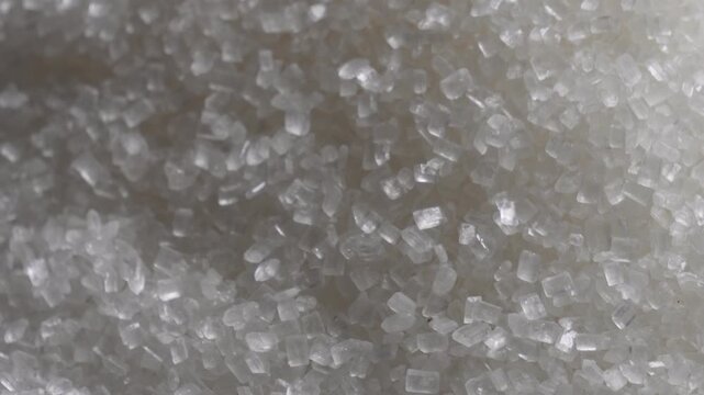 closeup of coarse white sugar crystals creating a natural texture