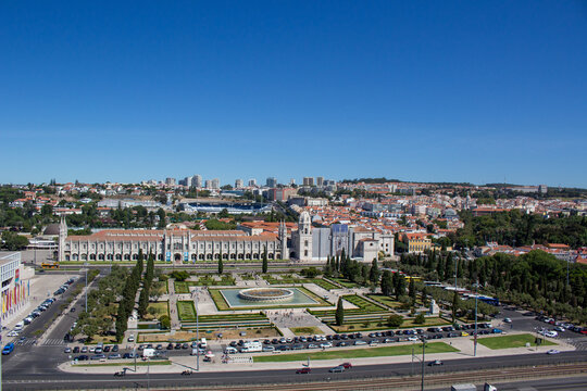 Lisbon, Portugal - 17 August 2017: View of the Jeronimos Monastery with its ornate facade, formal gardens, and fountains.