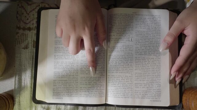 young conservative asian Woman Reading the Bible at table with bread food and drink indoors	

