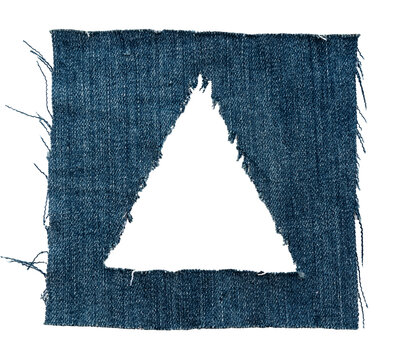 Hole in denim on a white background. Ripped jeans