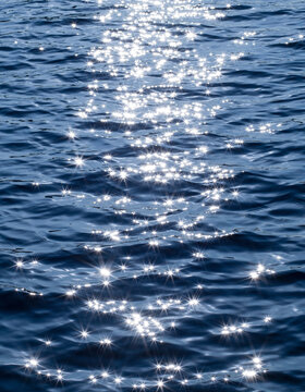 Sun glitter sparkling off the sea water surface