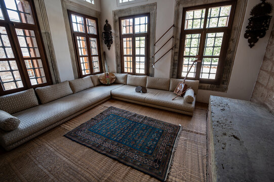 Istanbul,turkey,august 3, 2025. Interior of a traditional ottoman divan room inside the harem section of topkapi palace, featuring windows and a detailed rug