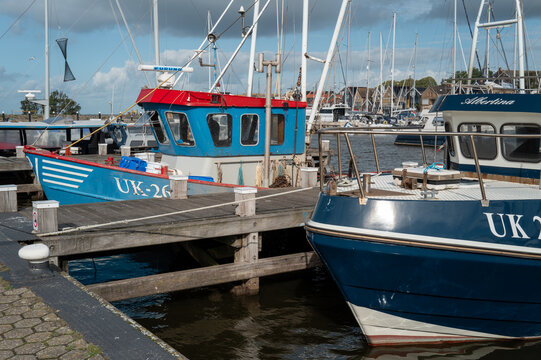 Urk, Flevoland, Netherlands, Fishing boats docked at a harbor in a small seaside town during daylight hours