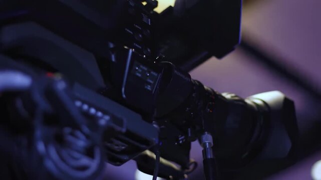 camcorder camera abstract close-up of a professional camcorder camera body in dark studio lighting