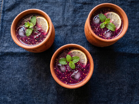 Falsa Sharbat Refreshing Berry Drink in Clay Cups on Dark Fabric