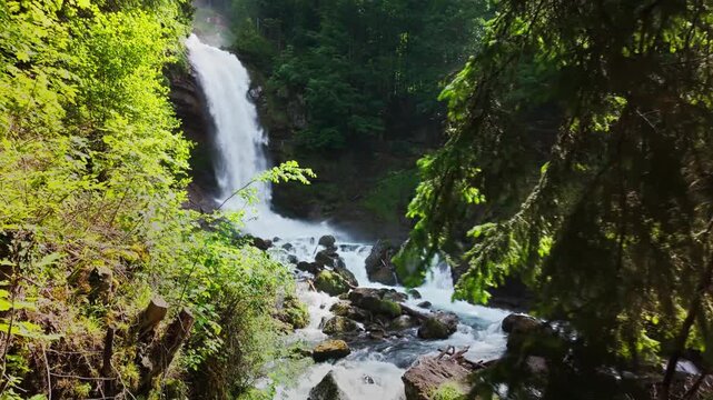 Giessbach Falls cascades through lush forest and rocky stream near Lake Brienz in the Bernese Oberland, Switzerland. 4K UHD video.
