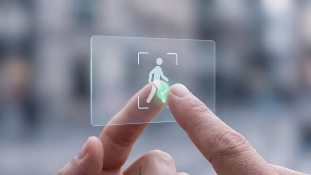 Person detection and identity recognition technology. Finger touching transparent screen with walking human scan frame and checkmark for AI surveillance, security, verification and monitoring