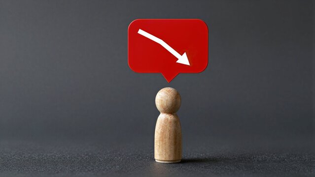 Wooden figure beneath red downward arrow, symbolizing decline or negative trend.