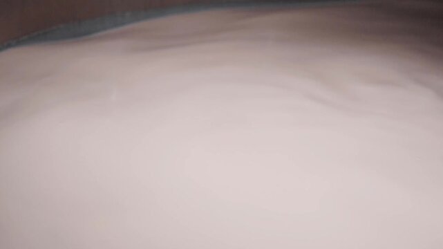 4k close up footage of mechanic arms mixing hot milk at the dairy factory. closeup of wire frames rotating in automated heating vat at cheese plant, cutting yellow mass into pieces and separating it f
