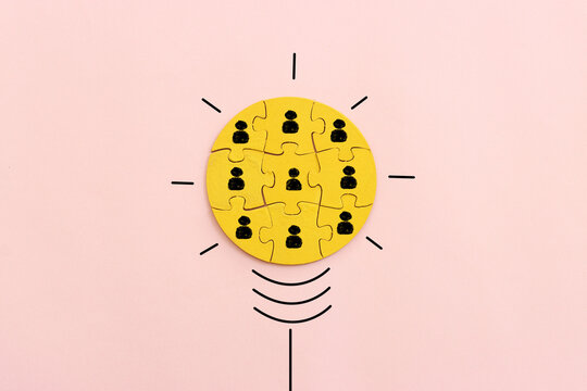 Wooden cubes with people icons over pastel background, human resources and management concept