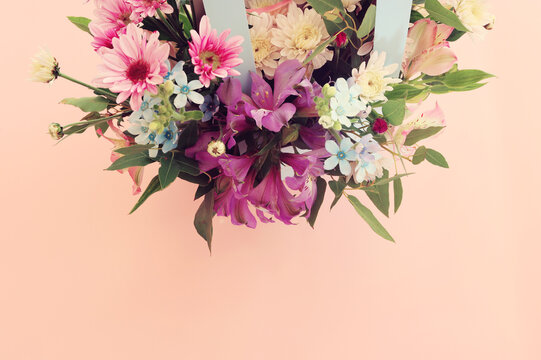 Top view image of romantic and delicate flowers on pastel background