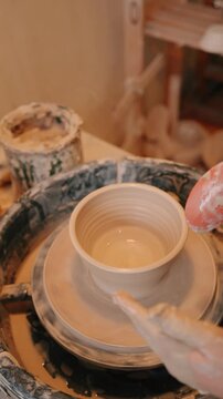 Handmade clay plate shaping on pottery wheel