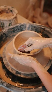 Handmade clay plate shaping on pottery wheel