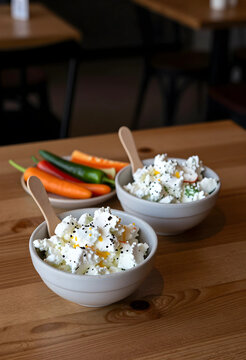 Healthy nutrition and clean eating, cottage cheese bowls with fresh vegetables for a balanced diet and weight loss meal plan on a wooden restaurant table