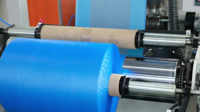 Automatic polyethylene plastic bag production machine with lighting effect. Close-up of troller of plastic bag production machine. product packaging concept