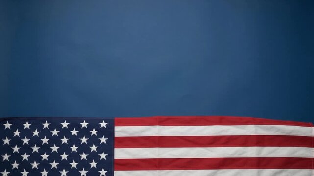 American flag waving gently in motion on blue background for memorial day and fourth of july video project.