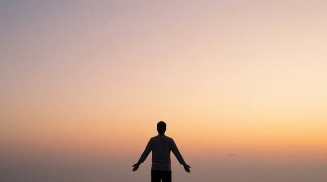 Solitary Person Standing Against a Peaceful Sunset Sky