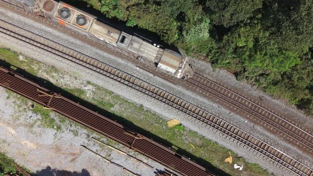 Cotia, Sao Paulo, Brazil - 26 August 2026: Aerial view of train and railway tracks running through the lush green landscape.